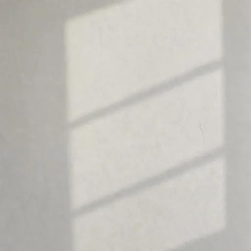 A pale plaster wall with a soft window-pane shadow falling across it — evoking quiet morning daylight.